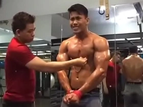 Gay Asian gym top’s nipple tease